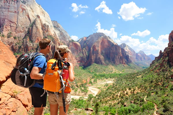 couple hiking in red mountains